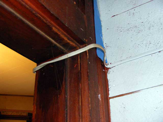 Across the ceiling and out the hall door.